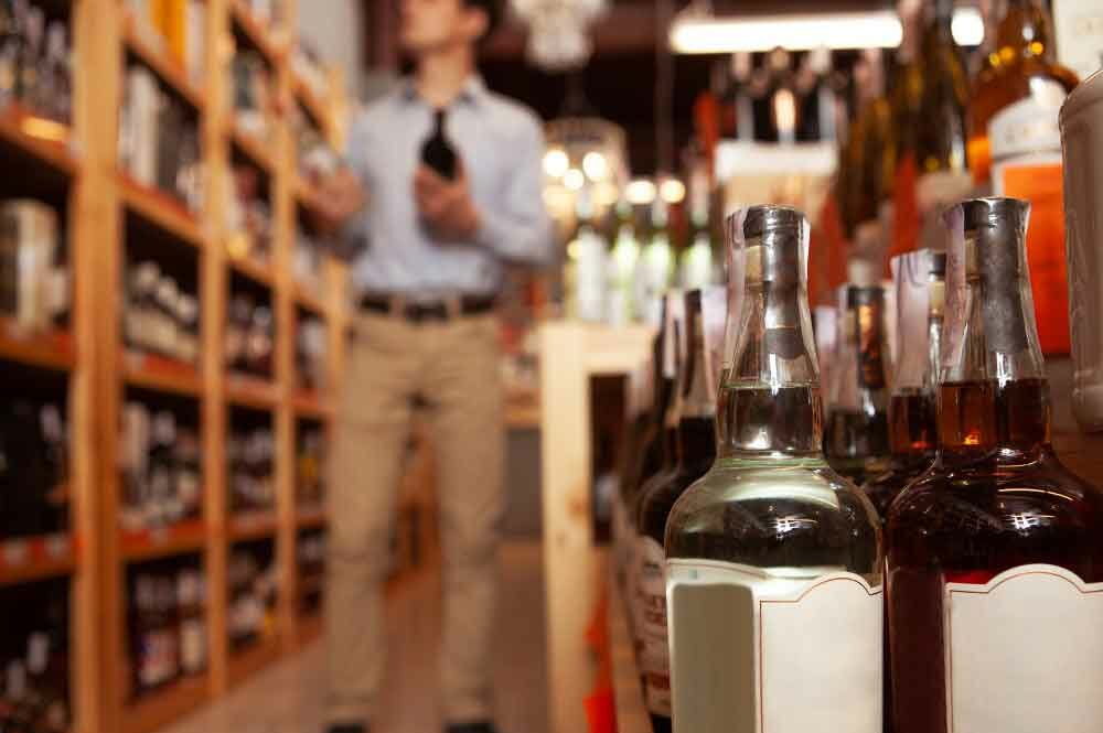 Packaging machinery from Packserv efficiently labeling bottles in the Alcohol and Distilleries Industry.