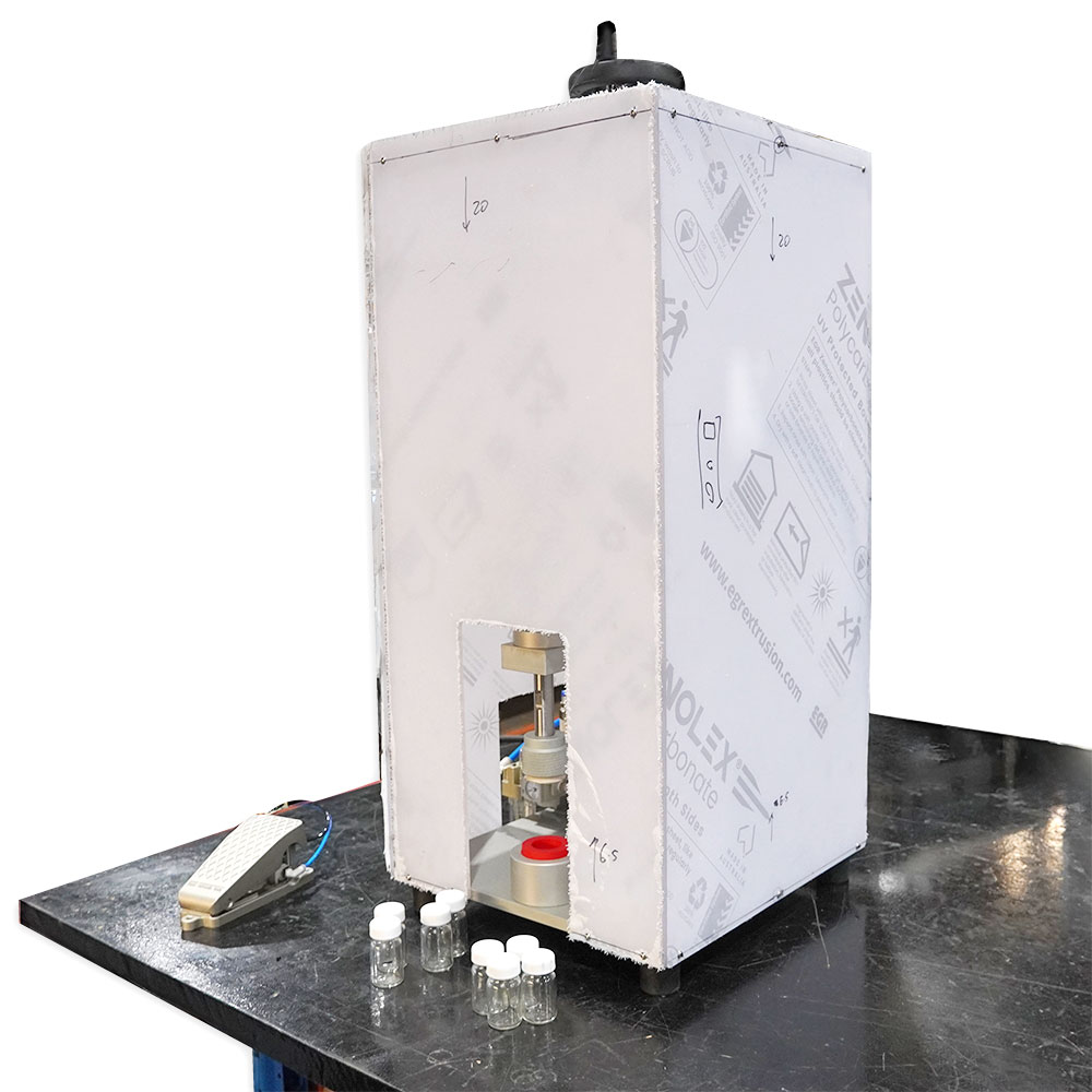 Bench model capper with safety guard for secure and efficient capping operations.